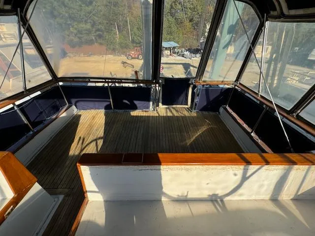 Slide: The Image of 1983 DeFever 41 Trawler interior with wooden flooring and large windows. - 13