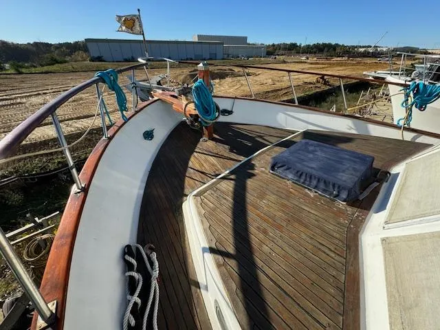 Slide: The Image of 1983 DeFever 41 Trawler deck with ropes and wooden flooring. - 14