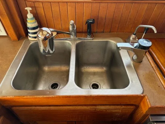 Slide: The Image of Stainless steel double sink on 1983 DeFever 41 Trawler with wooden countertop. - 26