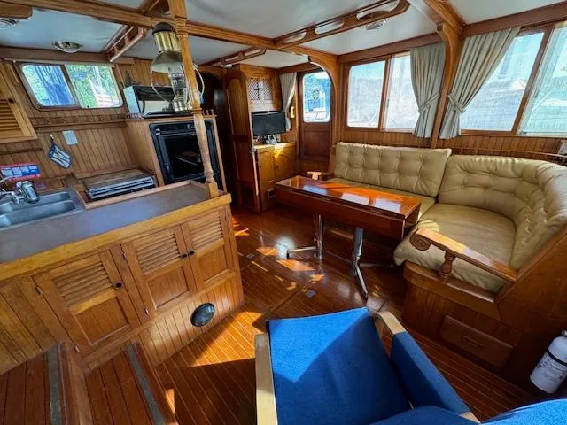 Slide: The Image of Cozy interior of 1983 DeFever 41 Trawler with wood paneling and seating area. - 27
