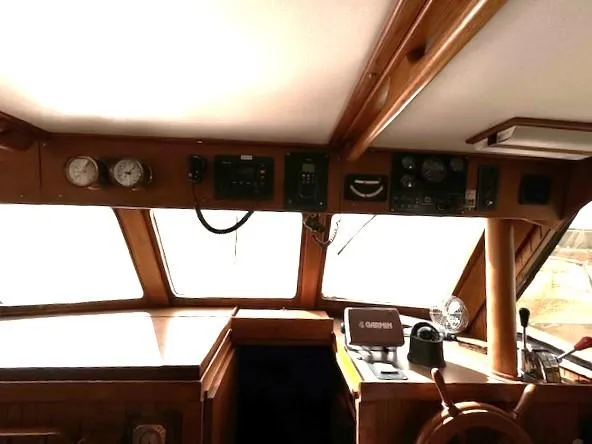 Slide: The Image of Interior helm of 1983 DeFever 41 Trawler with navigation instruments and wooden steering wheel. - 31