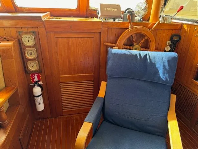 Slide: The Image of Cozy helm station of 1983 DeFever 41 Trawler with wooden wheel and blue chair. - 37