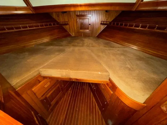 Slide: The Image of 1983 DeFever 41 Trawler cabin interior with wooden finish and storage compartments. - 41