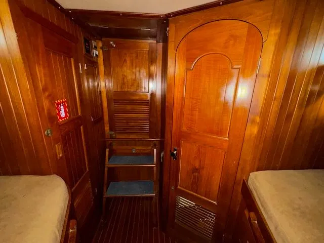 Slide: The Image of Interior of 1983 DeFever 41 Trawler with wooden paneling and cozy cabin layout. - 43