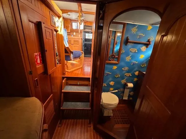 Slide: The Image of Interior of 1983 DeFever 41 Trawler with wooden finish and nautical-themed bathroom. - 45