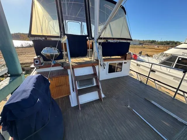 Slide: The Image of 1983 DeFever 41 Trawler deck with canopy and outdoor seating area. - 5