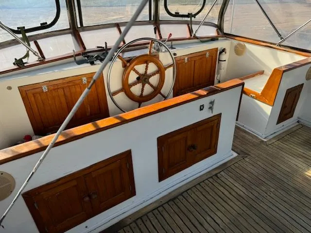 Slide: The Image of 1983 DeFever 41 Trawler helm with wooden wheel and cabinetry. - 8