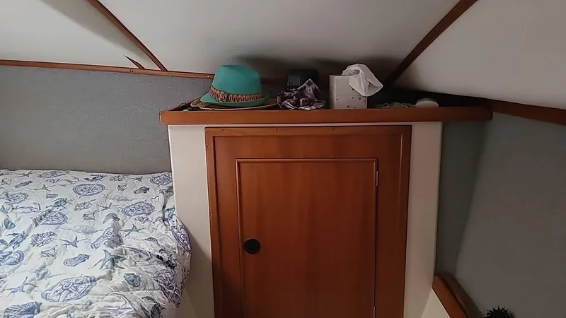 Slide: The Image of Cozy cabin interior of 1999 PDQ 36 with wooden cabinet and bed. - 13