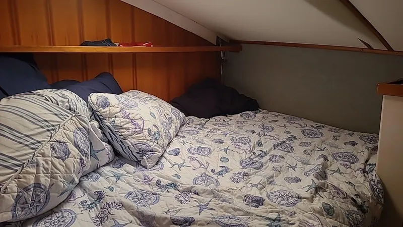 Slide: The Image of Cozy cabin bed with nautical-themed bedding in a 1999 PDQ 36 model. - 14