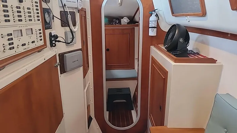Slide: The Image of Interior of a 1999 PDQ 36 boat with wood paneling and control panels. - 18