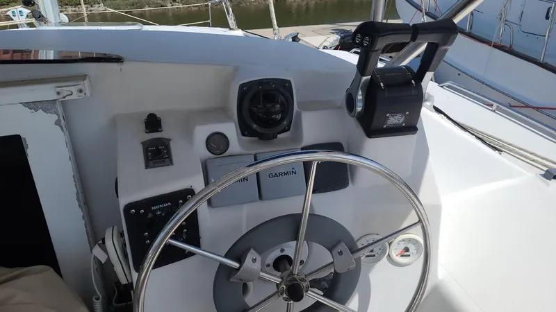 Slide: The Image of 1999 PDQ 36 boat helm with steering wheel and navigation equipment. - 5