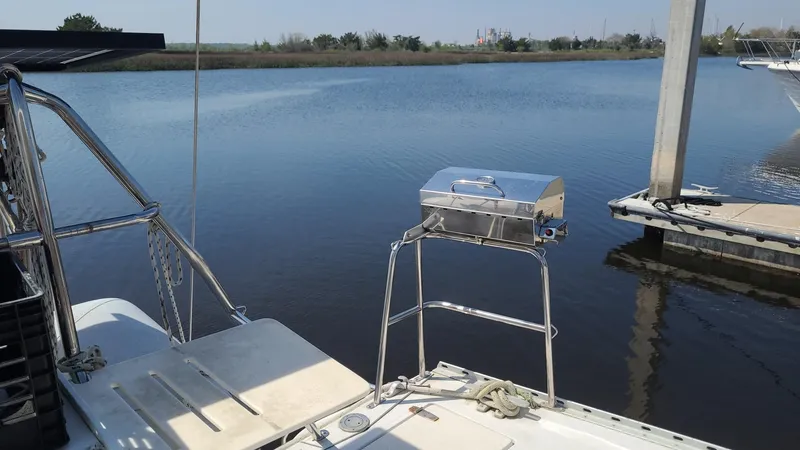 Slide: The Image of PDQ 36 catamaran with stainless steel grill on calm water. - 7