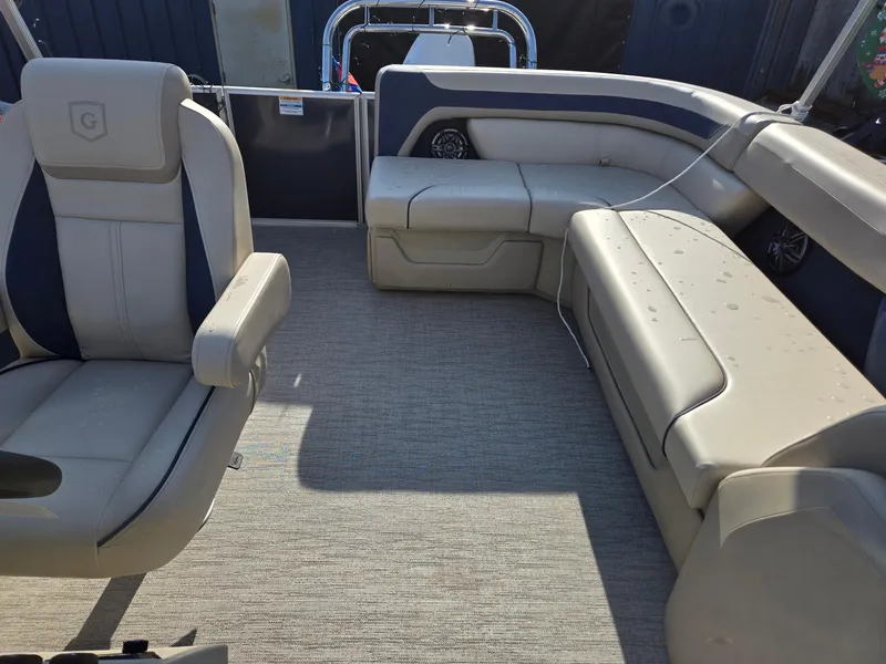 Slide: The Image of 2025 Godfrey Sweetwater 2086 C interior with beige seating and carpeted floor. - 11