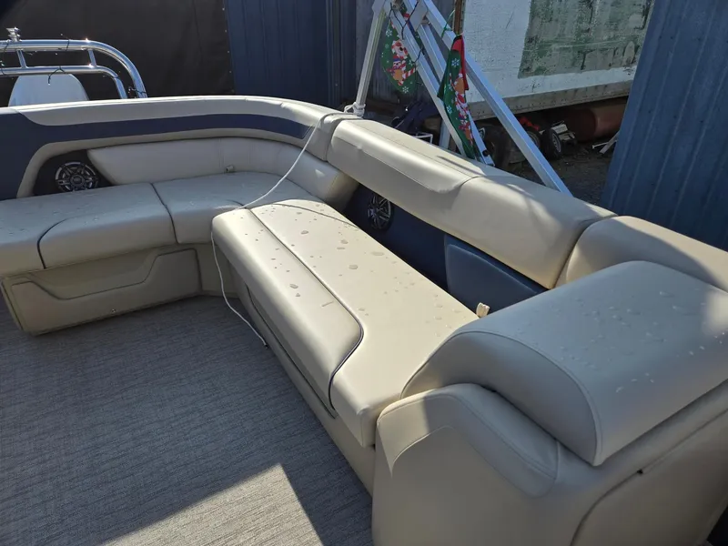 Slide: The Image of 2025 Godfrey Sweetwater 2086 C boat interior with beige seating and carpeted floor. - 12