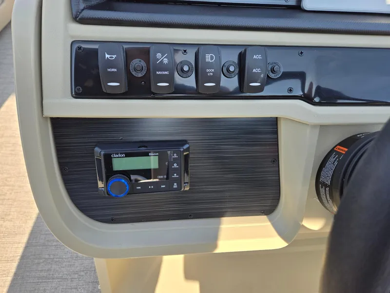 Slide: The Image of Control panel of 2025 Godfrey Sweetwater 2086 C boat with switches and audio system. - 16