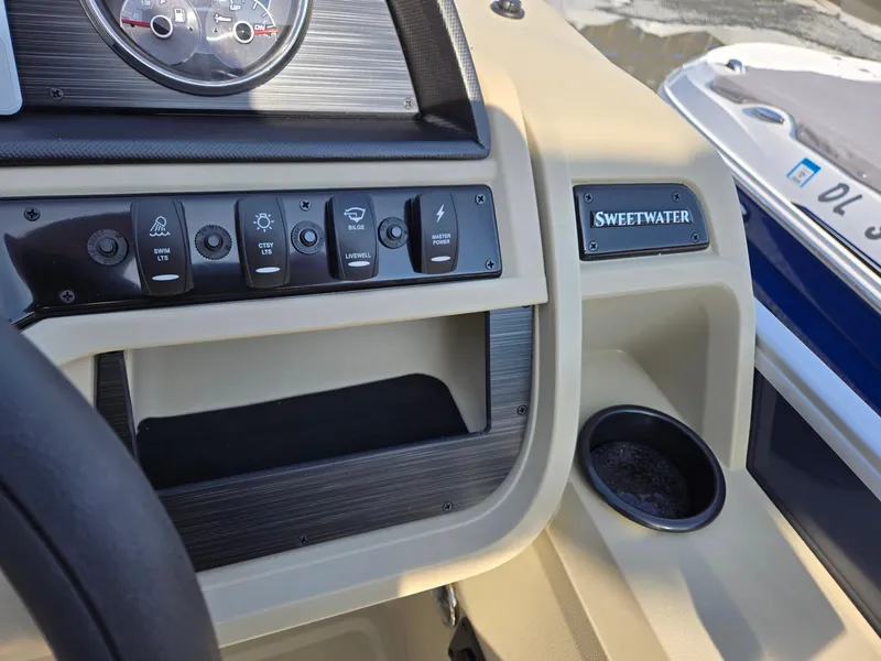 Slide: The Image of Dashboard of 2025 Godfrey Sweetwater 2086 C boat with control panel and cup holder. - 17