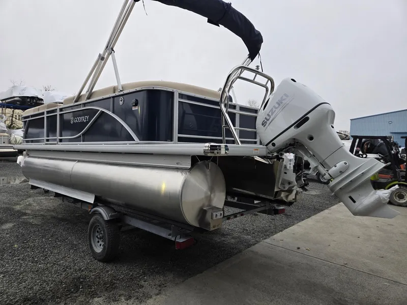 Slide: The Image of 2025 Godfrey Sweetwater 2086 C pontoon boat with outboard motor on trailer. - 2