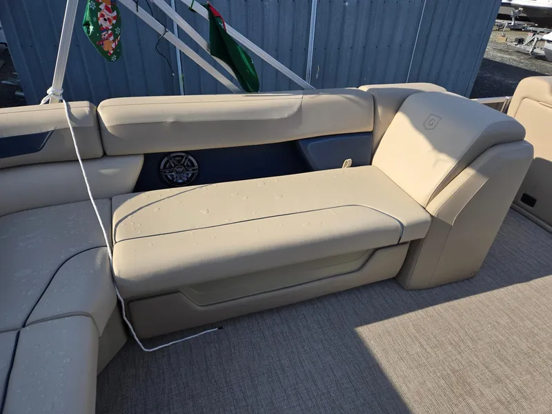 Slide: The Image of 2025 Godfrey Sweetwater 2086 C boat interior with beige seating and carpeted floor. - 24