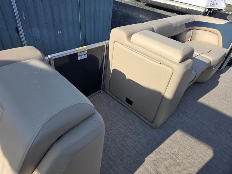 Slide: The Image of 2025 Godfrey Sweetwater 2086 C boat interior with beige seating and carpet flooring. - 26