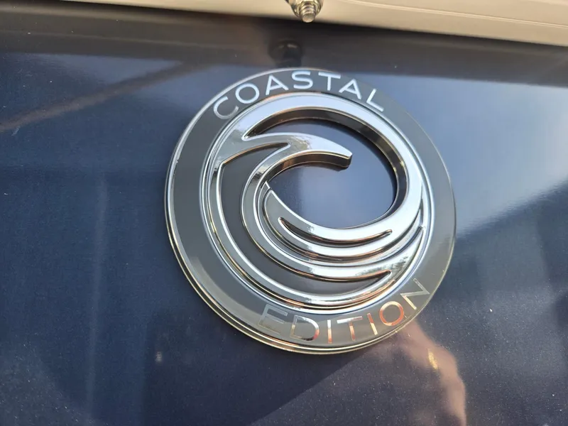 Slide: The Image of 2025 Godfrey Sweetwater 2086 C Coastal Edition emblem on blue surface. - 31