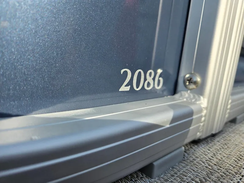 Slide: The Image of Close-up of 2025 Godfrey Sweetwater 2086 C model number on boat exterior. - 32