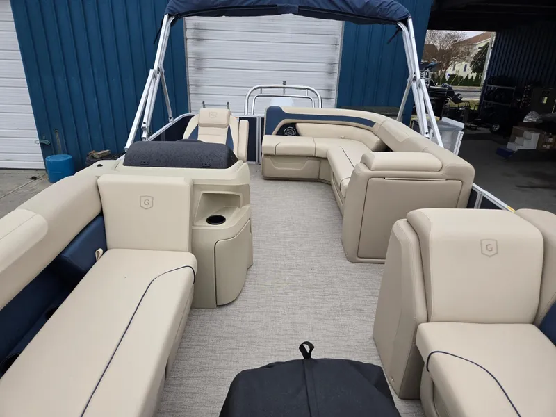 Slide: The Image of 2025 Godfrey Sweetwater 2086 C pontoon boat with beige seating and blue accents. - 8
