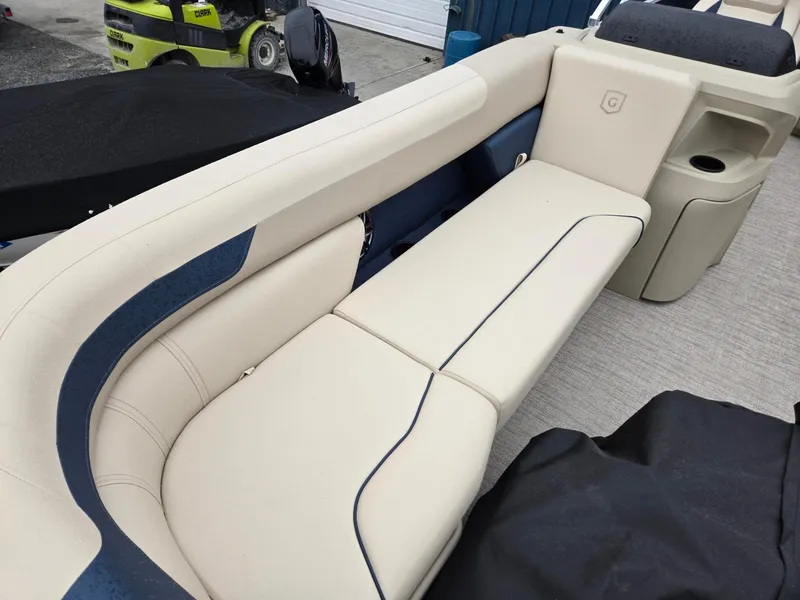 Slide: The Image of 2025 Godfrey Sweetwater 2086 C boat interior with beige seating and blue accents. - 9