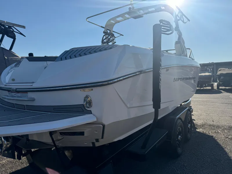 Slide: The Image of 2017 Nautique G25 boat on trailer, rear view, sunny day. - 2