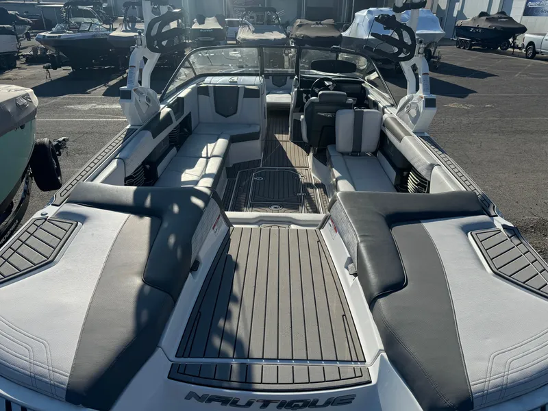 Slide: The Image of 2017 Nautique G25 boat interior with spacious seating and sleek design. - 6
