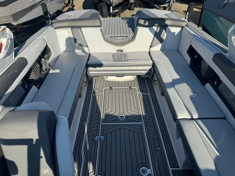 Slide: The Image of 2017 Nautique G25 boat interior with gray seating and detailed flooring. - 7