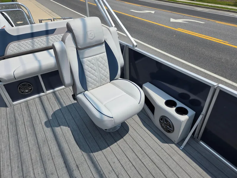 Slide: The Image of 2025 Godfrey SWEETWATER 2286 SFL boat interior with plush seating and cup holders. - 11