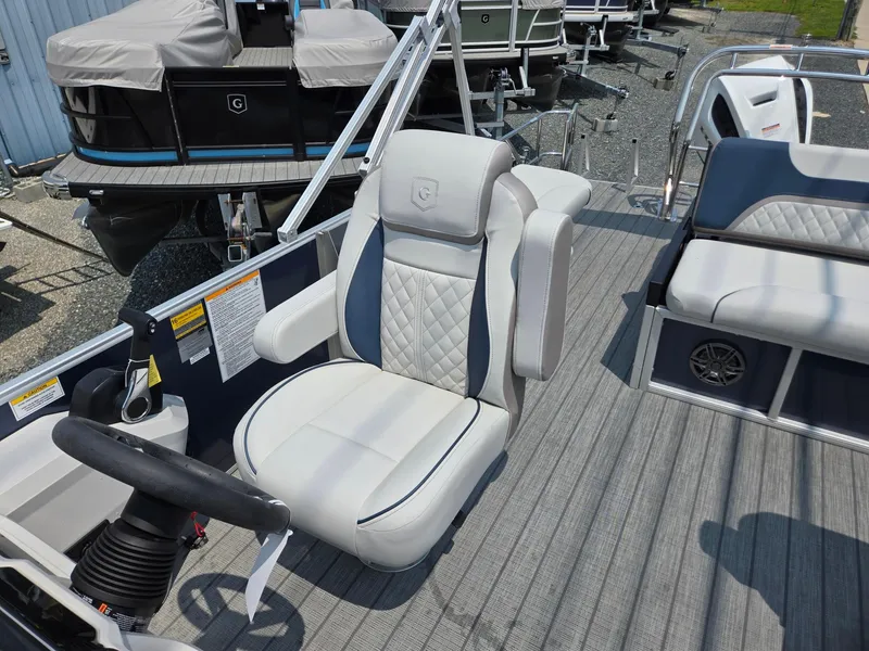 Slide: The Image of 2025 Godfrey SWEETWATER 2286 SFL boat interior with luxury seating and steering wheel. - 12