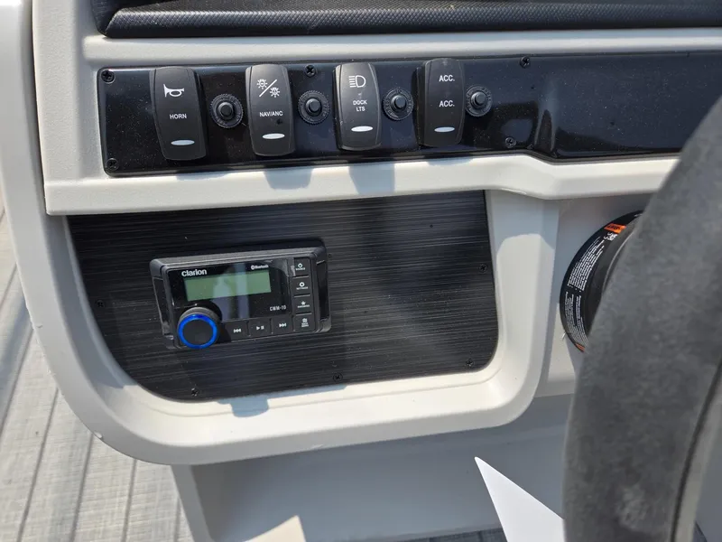 Slide: The Image of Control panel of 2025 Godfrey SWEETWATER 2286 SFL boat with switches and audio system. - 15