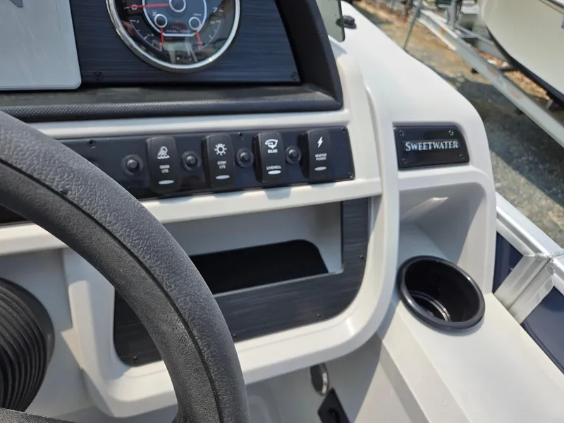 Slide: The Image of Control panel of 2025 Godfrey SWEETWATER 2286 SFL boat with steering wheel and cup holder. - 16