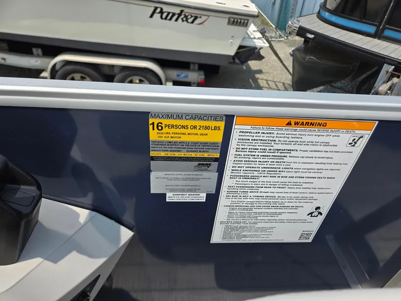 Slide: The Image of 2025 Godfrey SWEETWATER 2286 SFL boat capacity warning label, 16 persons or 2180 lbs. - 18
