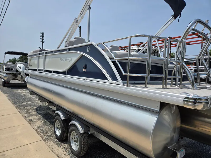 Slide: The Image of 2025 Godfrey SWEETWATER 2286 SFL pontoon boat on trailer, side view. - 2