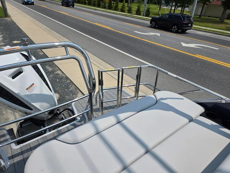 Slide: The Image of 2025 Godfrey SWEETWATER 2286 SFL pontoon boat parked near a road. - 22