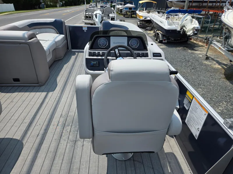 Slide: The Image of 2025 Godfrey SWEETWATER 2286 SFL boat interior with helm and seating. - 27