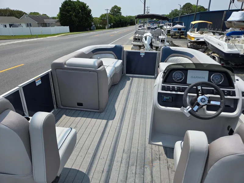 Slide: The Image of 2025 Godfrey SWEETWATER 2286 SFL pontoon boat interior with seating and steering console. - 28