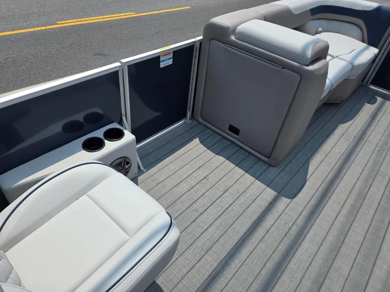 Slide: The Image of 2025 Godfrey SWEETWATER 2286 SFL boat interior with gray seating and cup holders. - 29
