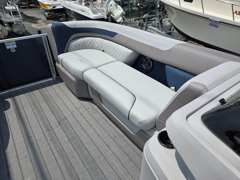 Slide: The Image of 2025 Godfrey SWEETWATER 2286 SFL boat interior with plush seating and modern design. - 32