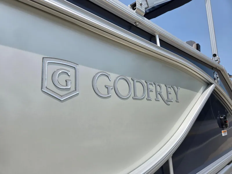 Slide: The Image of 2025 Godfrey SWEETWATER 2286 SFL boat side view with logo detail. - 35