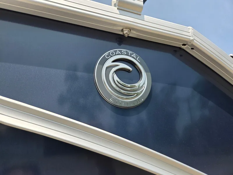 Slide: The Image of 2025 Godfrey SWEETWATER 2286 SFL boat with Coastal emblem on blue surface. - 36