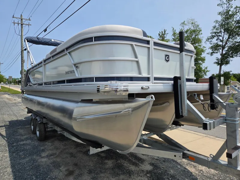 Slide: The Image of 2025 Godfrey SWEETWATER 2286 SFL pontoon boat on trailer, parked outdoors. - 6