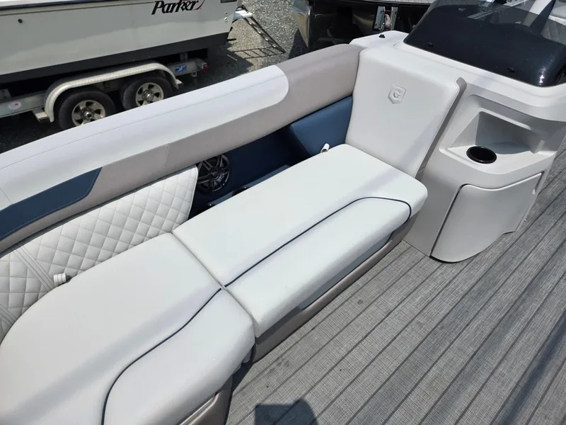 Slide: The Image of 2025 Godfrey SWEETWATER 2286 SFL boat interior with cushioned seating and cup holder. - 8