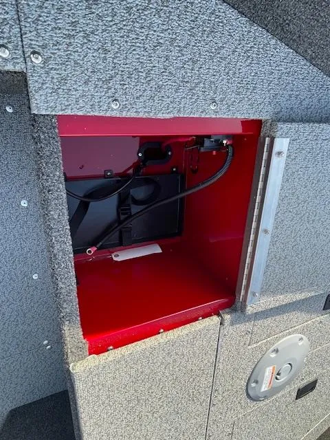 Slide: The Image of 2025 Lund 1650 Angler SS storage compartment with red interior and wiring. - 19