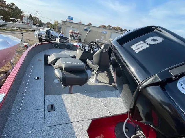 Slide: The Image of 2025 Lund 1650 Angler SS boat interior with seating and motor. - 3