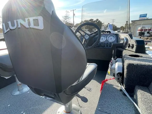 Slide: The Image of 2025 Lund 1650 Angler SS boat interior with steering wheel and dashboard. - 8