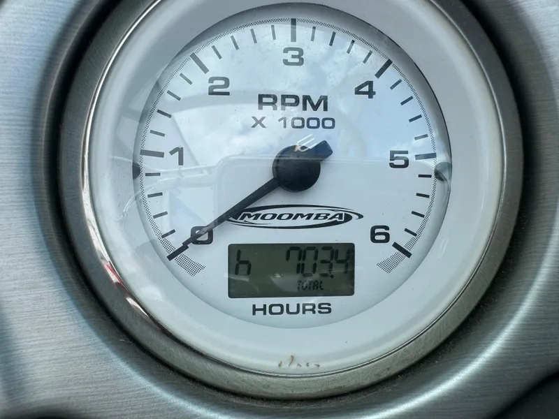 Slide: The Image of 2006 Moomba XLV RPM gauge displaying 703.4 hours. - 11