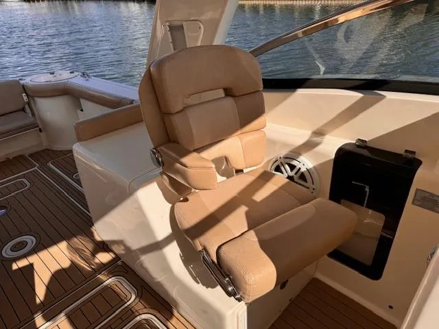 Slide: The Image of 2018 Scout 275 Dorado boat interior with tan seating and wood flooring. - 10